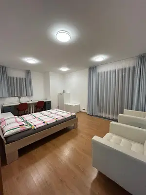 a room with a bed and a table and chairs at Krásné ubytování s balkonem in Prague