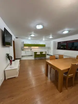 a dining room and kitchen with a table and chairs at Krásné ubytování s balkonem in Prague