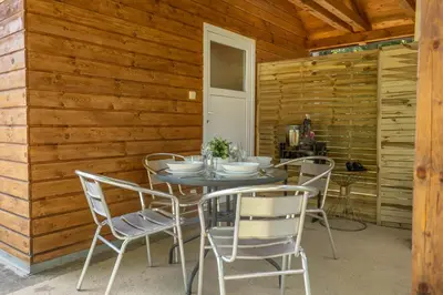 a dining room with a table and chairs at Magic new cozy tiny house at private lake in Řehenice
