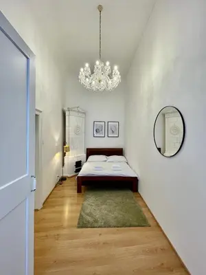 a bedroom with a bed and a mirror on the wall at Masná 20C- Old Town Residence in Prague