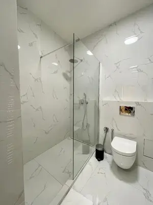 a white bathroom with a shower and a toilet at Masná 20C- Old Town Residence in Prague
