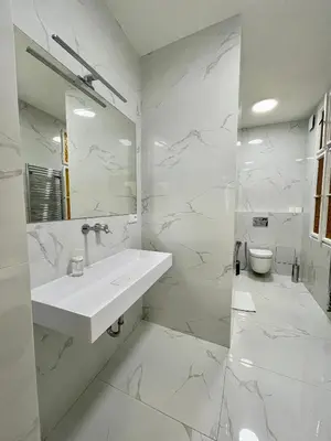 a white bathroom with a sink and a toilet at Masná 20C- Old Town Residence in Prague