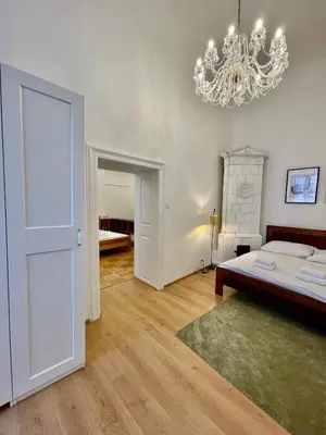 a bedroom with a bed and a chandelier at Masná 20C- Old Town Residence in Prague