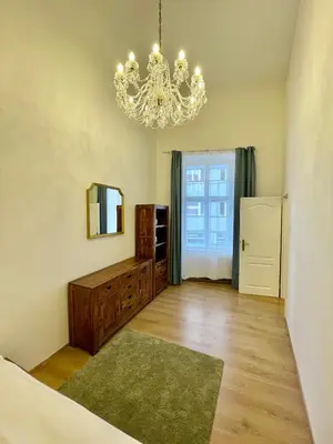 a living room with a chandelier and a room at Masná 20C- Old Town Residence in Prague