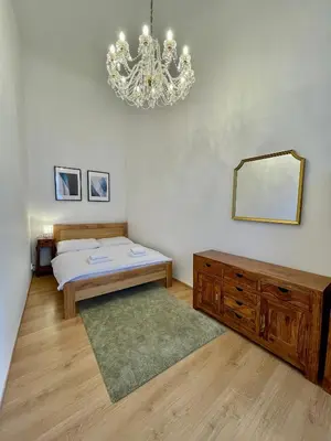 a bedroom with a bed and a chandelier at Masná 20C- Old Town Residence in Prague