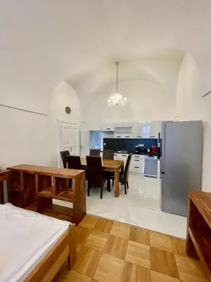 a kitchen and dining room with a table and refrigerator at Masná 20C- Old Town Residence in Prague
