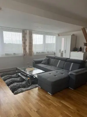a living room with a couch and a coffee table at Vila v Brdech s bazénem, infra saunou a vybavením in Malá Víska