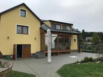 a house with a pole in front of it at Vila v Brdech s bazénem, infra saunou a vybavením in Malá Víska
