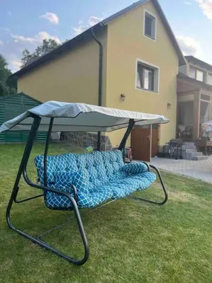 a bed in the grass with a canopy on it at Vila v Brdech s bazénem, infra saunou a vybavením in Malá Víska