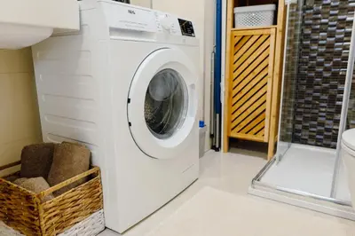 a white washer and dryer in a bathroom at Modern Mezzanine Apt at Jecna st in Prague