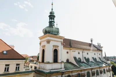 a building with a clock tower on top of it at Modern Mezzanine Apt at Jecna st in Prague