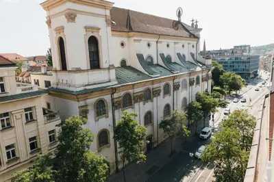 a large white building with a street in front of it at Modern Mezzanine Apt at Jecna st in Prague