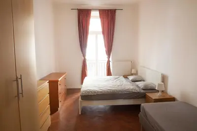 a bedroom with a bed and a window at 2 Bed Flat - Sleeps 9 - Pets - Smoking on terrace in Prague