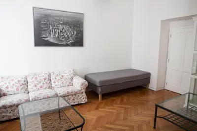 a living room with a couch and a ottoman at 2 Bed Flat - Sleeps 9 - Pets - Smoking on terrace in Prague