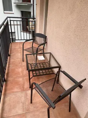 two chairs and a table on a balcony at 2 Bed Flat - Sleeps 9 - Pets - Smoking on terrace in Prague