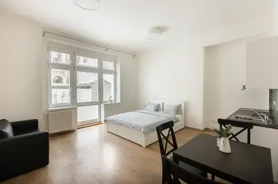 a bedroom with a bed and a table and a desk at Cozy Studio in quiet courtyard near Charles Bridge in Prague