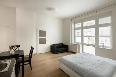 a bedroom with a bed and a desk and a chair at Cozy Studio in quiet courtyard near Charles Bridge in Prague