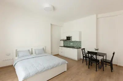a bedroom with a bed and a table with chairs at Cozy Studio in quiet courtyard near Charles Bridge in Prague