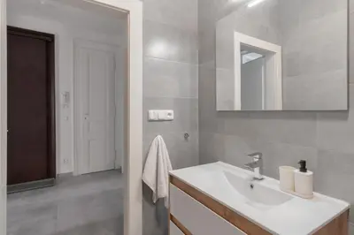 a bathroom with a sink and a mirror at Prague Days - Modern Apartments just 7 min from Wenceslas Square in Prague