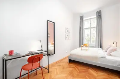 a bedroom with a bed and a desk and a chair at Prague Days - Modern Apartments just 7 min from Wenceslas Square in Prague