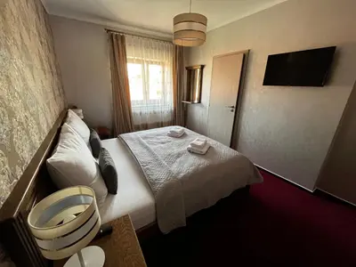 a hotel room with a bed and a window at Elodia in Choťánky