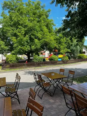 a wooden table and chairs sitting on a patio at Elodia in Choťánky