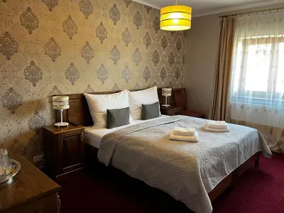 a bedroom with a bed with two towels on it at Elodia in Choťánky