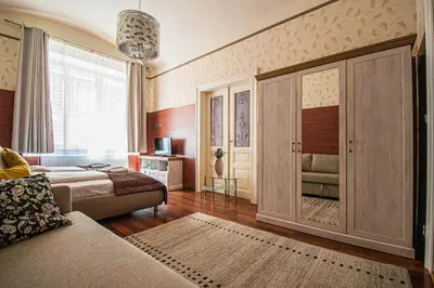 a living room with a couch and a large window at Central 2BDR flat behind Museum in Prague