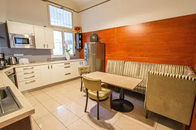 a kitchen with a table and a couch in it at Central 2BDR flat behind Museum in Prague