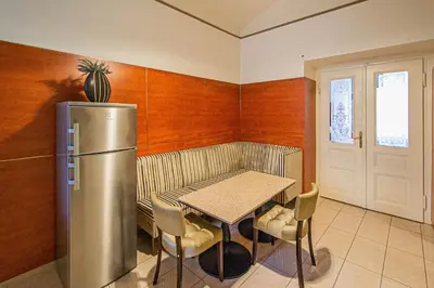 a small kitchen with a table and a refrigerator at Central 2BDR flat behind Museum in Prague