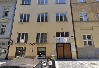 a building with a car parked in front of it at Central 2BDR flat behind Museum in Prague