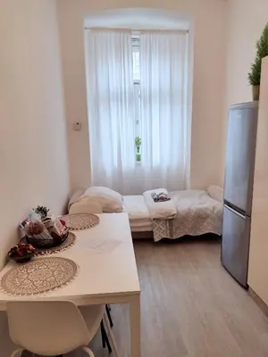 a small room with a kitchen with a refrigerator at Viaducto de Karlín - Aparment in Prague