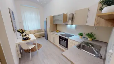 a small kitchen with a sink and a table at Viaducto de Karlín - Aparment in Prague