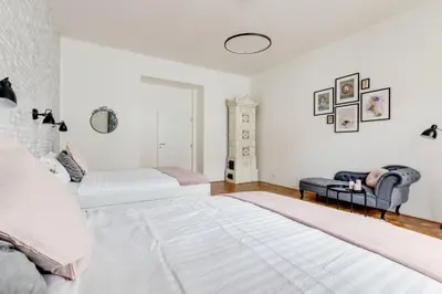 a white bedroom with a bed and a couch at Modern & Stylish Prague Apartments, Multiple Units in Prague