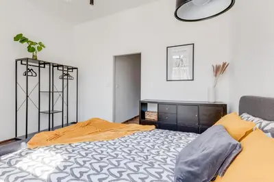 a bedroom with a bed and a dresser at Modern & Stylish Prague Apartments, Multiple Units in Prague