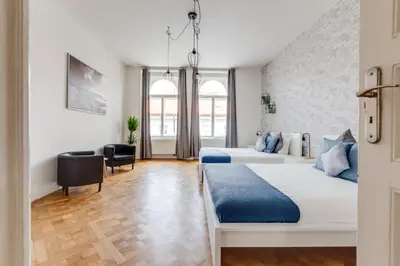 a bedroom with two beds and a desk at Modern & Stylish Prague Apartments, Multiple Units in Prague