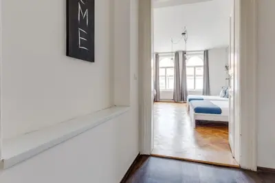 a hallway with a mirror and a bed in a room at Modern & Stylish Prague Apartments, Multiple Units in Prague