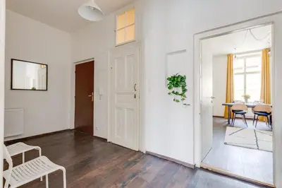 a white living room with a table and chairs at Modern & Stylish Prague Apartments, Multiple Units in Prague