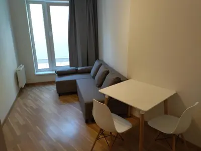 a living room with a couch and a table at Brand new one bedroom apartment #54 in brand new building with free parking in Prague