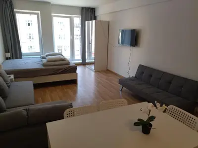 a living room with a couch and a table at Brand new one bedroom apartment #54 in brand new building with free parking in Prague