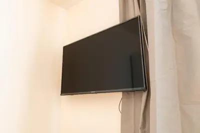 a flat screen tv hanging on a wall at Brand new one bedroom apartment #54 in brand new building with free parking in Prague