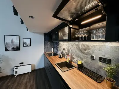 a kitchen with a sink and a counter top at Grand Viceroy Apartments - Gothic Tower View in Prague