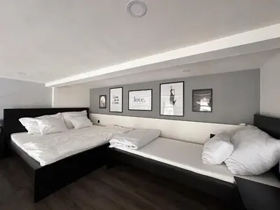 a bedroom with two beds with white sheets and pillows at Grand Viceroy Apartments - Gothic Tower View in Prague