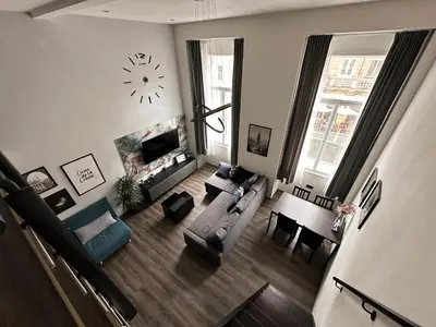 an overhead view of a living room with a clock at Contemporary Jindřišská Apartment in Prague