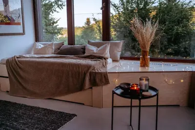 a bedroom with a bed and a window and a table at Chata nad Kocábou in Štěchovice
