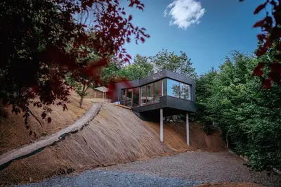 a glass house on top of a hill at Chata nad Kocábou in Štěchovice