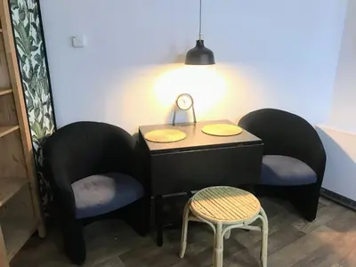 a small table with two chairs and a lamp at Fun Tiki Vibe Apartment / Charles Bridge / Netflix in Prague