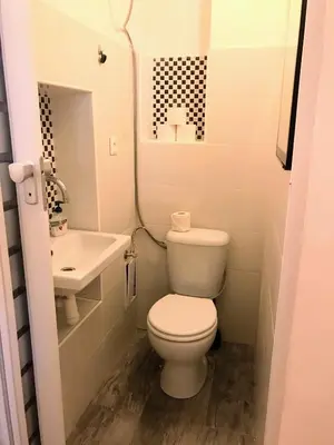 a small bathroom with a toilet and a sink at Fun Tiki Vibe Apartment / Charles Bridge / Netflix in Prague