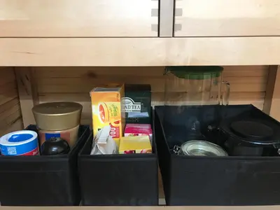 a black box sitting under a cabinet with food at Fun Tiki Vibe Apartment / Charles Bridge / Netflix in Prague
