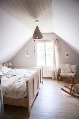 a bedroom with a large bed in a attic at Domeček na Květinovém statku in Zdice